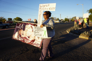Center, Christine Winfield of Santa Fe, attempts to block a Knights of Columbus pro life banner on Cerillos road on Wednesday Oct 6, 2014. Photo by Luke E. Montavon/The Jackalope