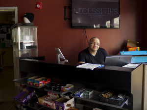 Daniel Sanchez working at the counter of necessities. 