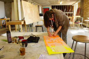 Studio art major, Samantha Narhuminti, founder of the Drawing on Trees club, cuts stencils for a collaborative piece during their weekly meeting on Mar 08. 2015. Photo by Luke E. Montavon