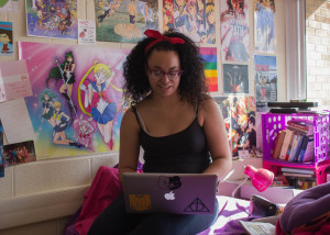 Chantelle Mitchell writes in her dorm. Photo by Kyleigh Carter