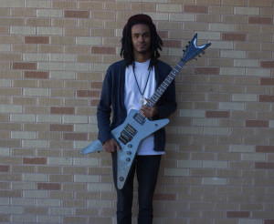 Shar Clay, a sophomore, and a contemporary music major, poses with his guitar.