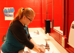 Dee Rose in the gender neutral bathroom. Photo by Lauren Eubanks