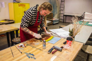 Hana Patrick works on a inked plate. Photo by Christy Marshall