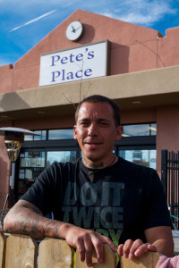 Robert Villalobos leaning on the fence outside of Pete's Place. Image by Whitney Wernick