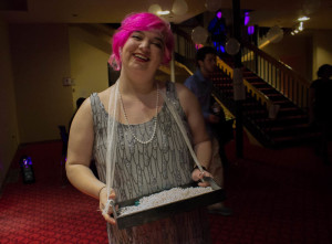 Sophomore Tech Theater major Emily Curly hands out beaded necklaces to guests. Photo by Kyleigh Carter