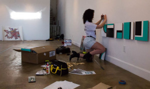 Hannah Marcotte installs her piece at Wade Willson. Photo by Christy Marshall