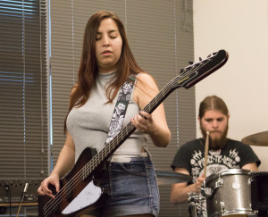 Jacinda plays her bass in class on a day they learn a new song. Photo By Christy Marshall
