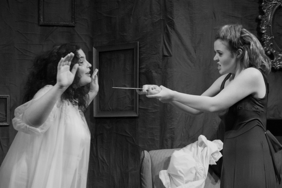 Estelle, played by Trestine Henderson, threatens Ines, played by Chloie Torblaa, character with a letter opener.