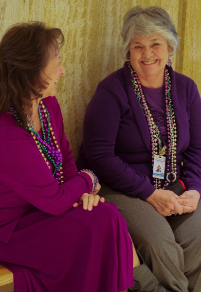 Two tour guides share a laugh while they await their next guests.