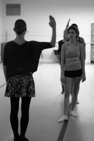 Marisa Melito watches as Shannon Elliott demonstrates the precision that she wants to see in the movement.