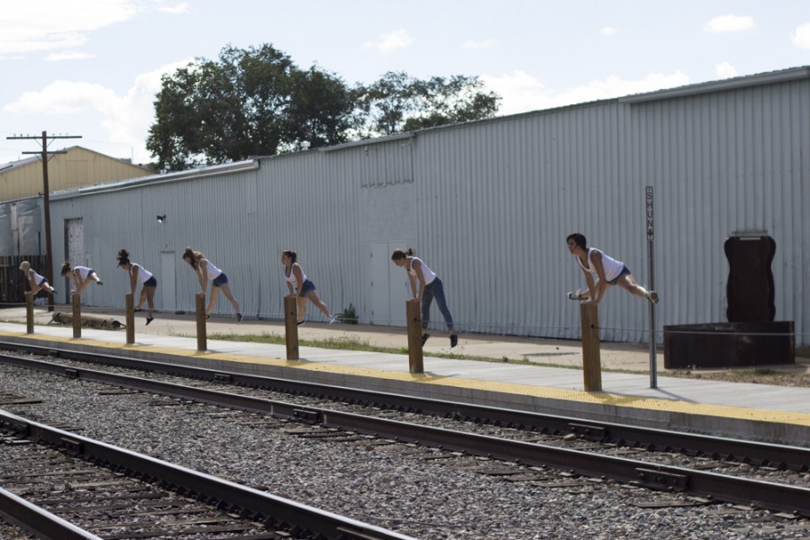 Shannon Elliott choreographed the site specific piece to incorporate the fence posts on the side of the railroad track. Photo by Amanda Tyler