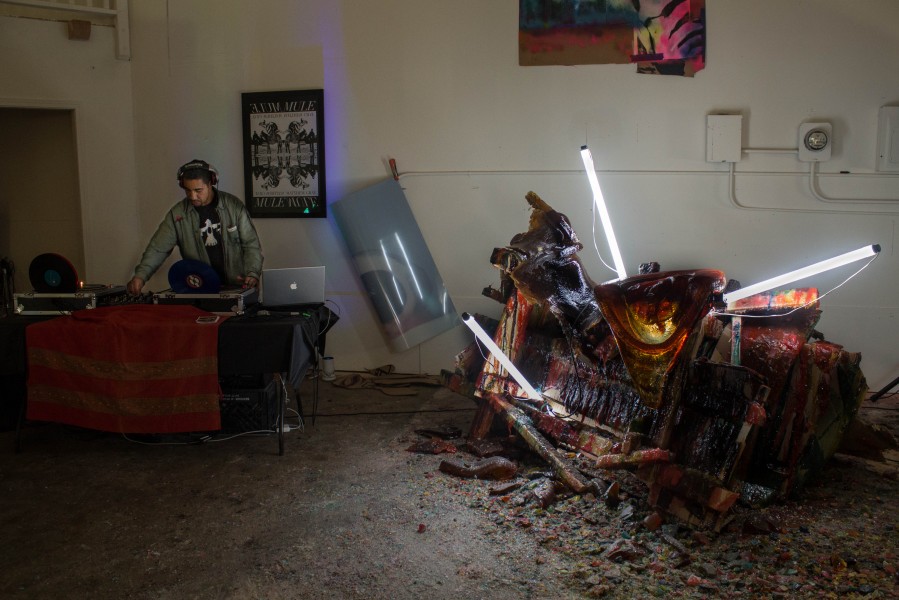 Dj Aztec Sol spins next to Matthew Grays renditions of a car crash.
