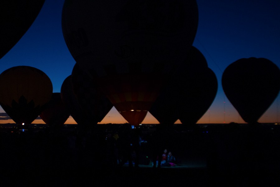 Silhouettes of the balloons stand against the Albuquerque sunset. Photo by Amanda Tyler.