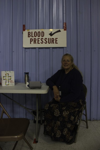 Angie Howes offering blood pressure checks. Photo by Amanda Tyler.