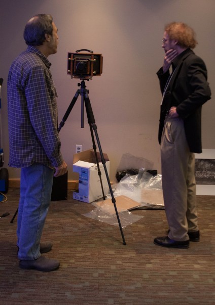Richard Puckett and an attendee talk about large format cameras.