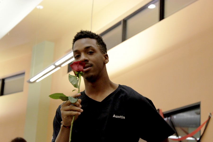 Austin Ross smells the roses at the Date Auction. Photos by Max Matias