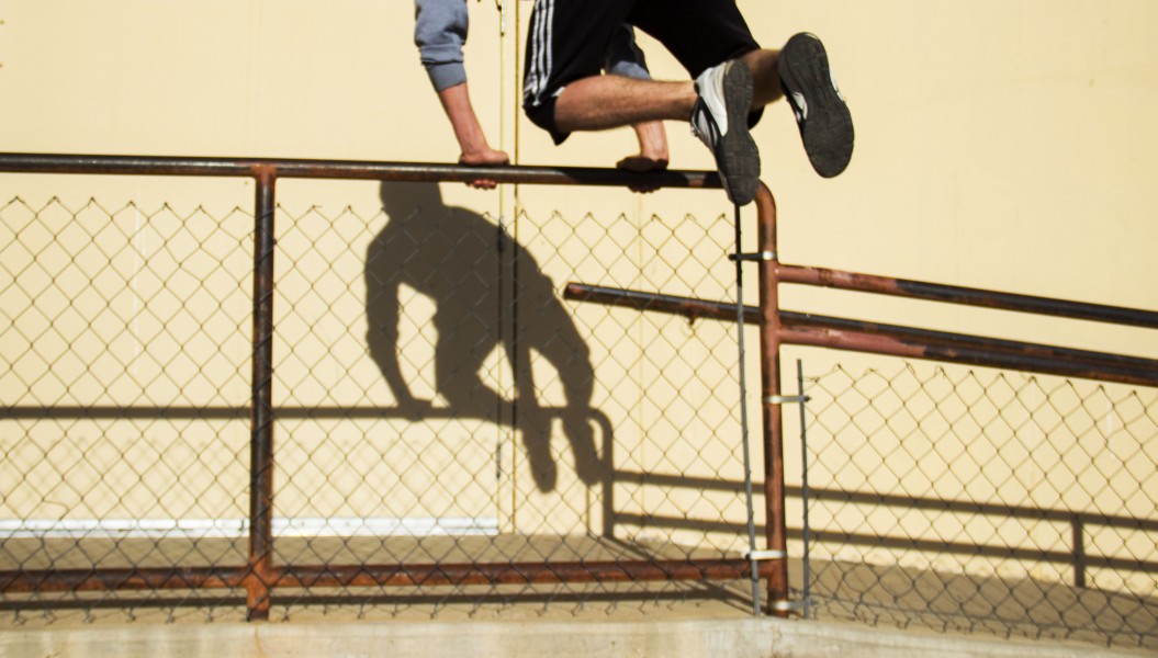 Gallegos jumping over a fence.