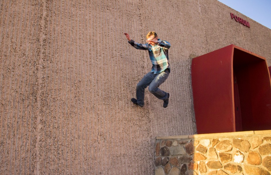 Drew Stahlein jumping over a wall outside the Forum.