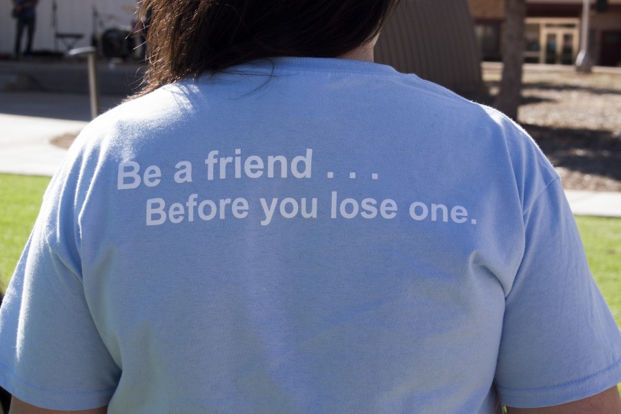 Chelsea Garcia shows the back of the suicide awareness shirts 
