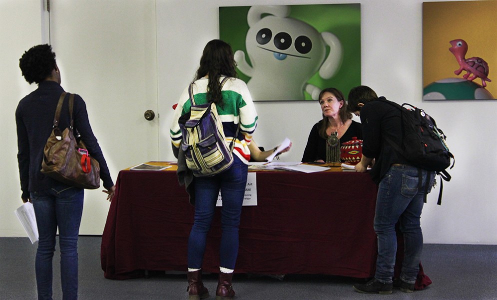 At SFUAD’s Job Fair, students filled out applications for the Santa Fe International Folk Art Market. Photo by Max Matias.
