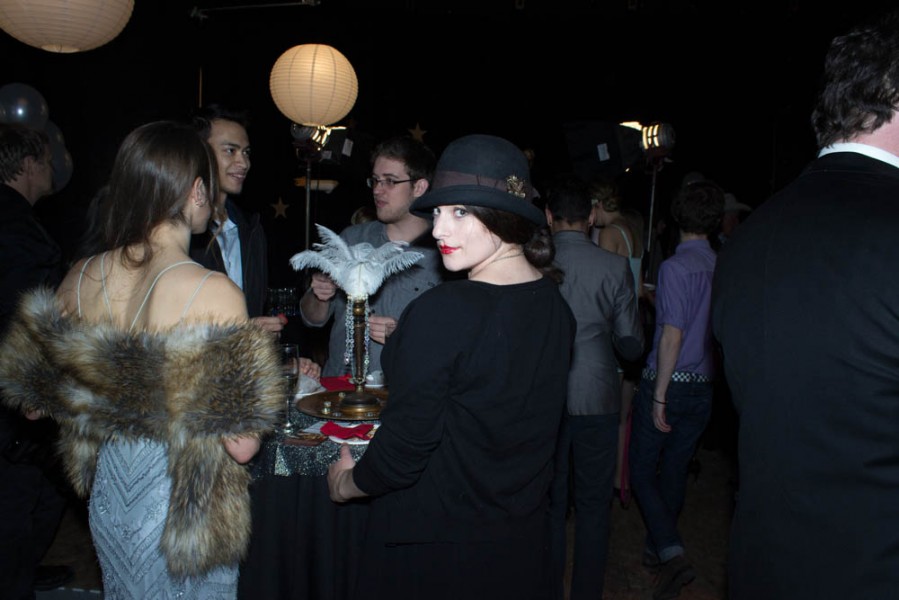 A woman gazes over her shoulder as guests arrive. Photo By Ash Haywood