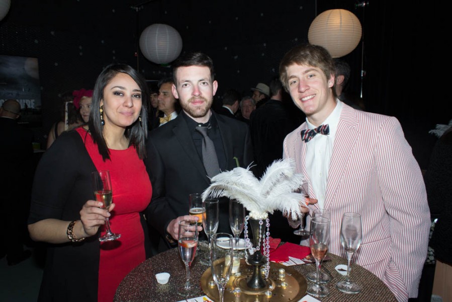 Students Elva Gara, Chris Beran, and Will Gallegos enjoy champagne in their Gatsby attire. 