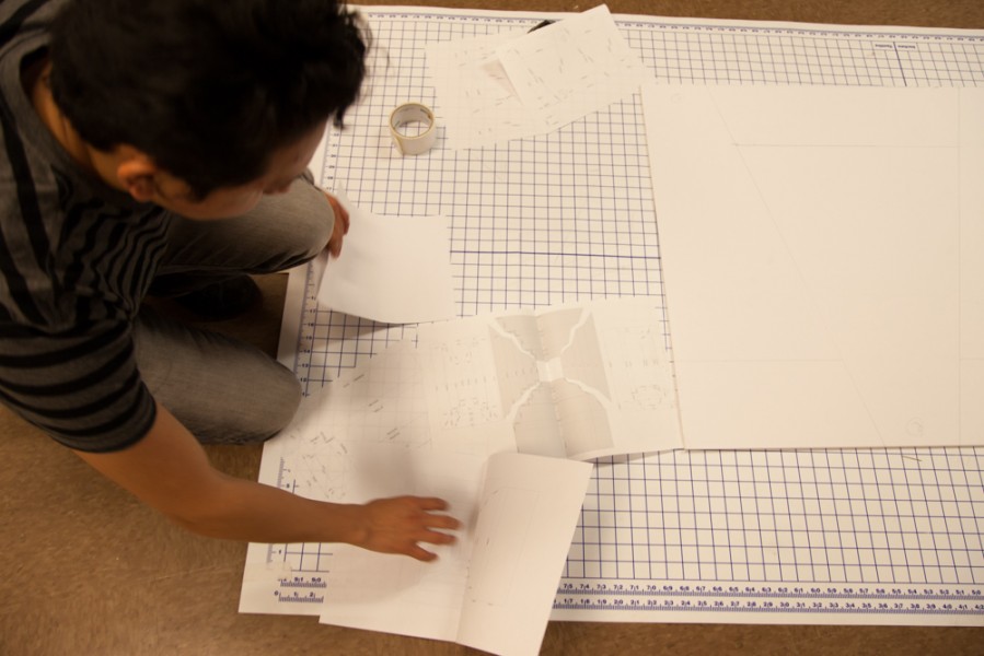 Preparing for cutting, Arnold Mateos looks through multiple diagrams.