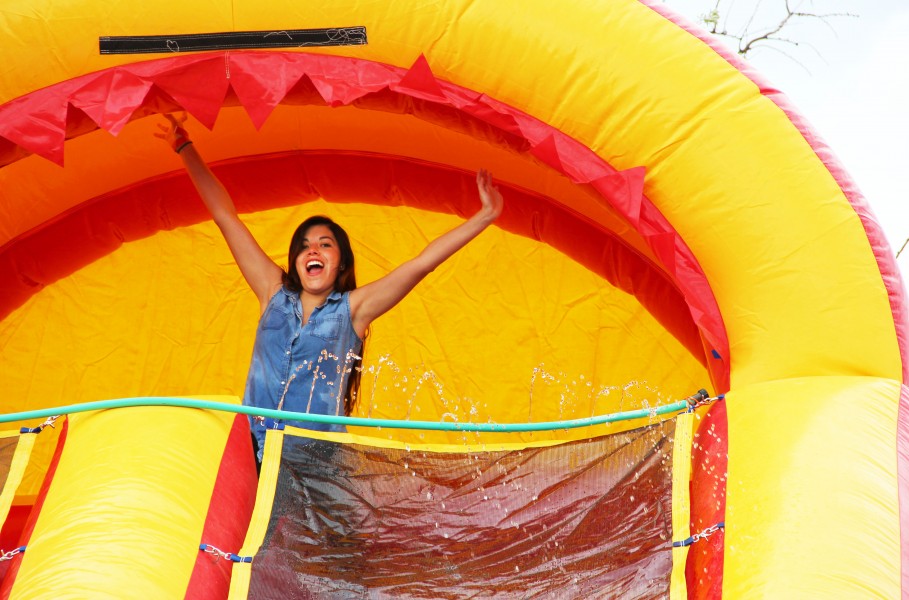 Cynthia Galvan about to throw herself into the inflatable bouncer. A pool of water waited at the bottom.