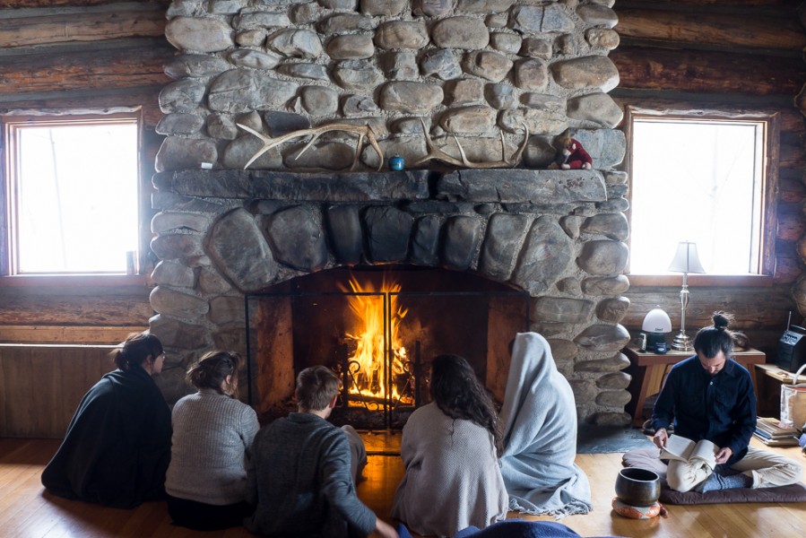 Students get cozy by the fire before morning practice. Photo by Luke Montavon 