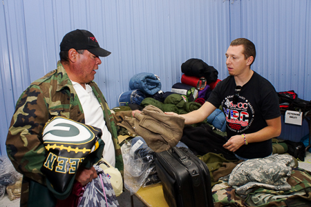 From right, volunteer Adrien Martinez distributes clothing to Vets like USMC Ret. MSSGT Luis Gallegos during the Veterans Standown on Friday October 24, 2014. Photo by Luke E. Montavon/The Jackalope