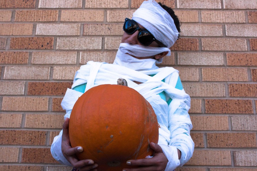 Yanis Solis in disguise as a mummy while holding a pumpkin. photo by Humberto Loeza