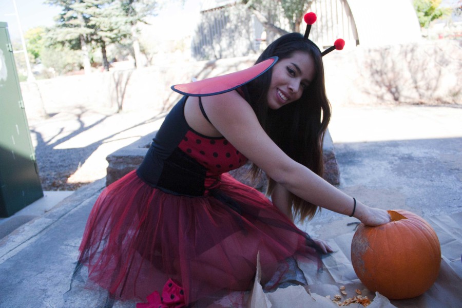Berenice Chavez in disguise as a ladybug stuffing a pumpkin. photo by Humberto Loeza