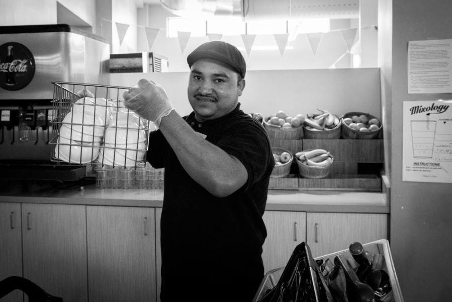 Alonso Hemones, cafeteria employee, setting up for the evening feeding frenzy.  Photo by Jessie Leigh