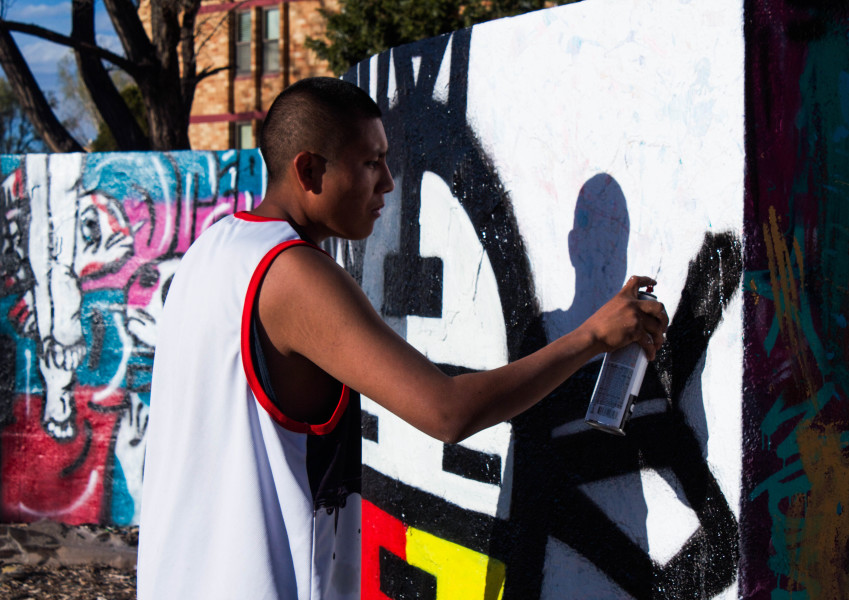 Young graffiti artist Edward Valdez spends the day doing his art. Photo by Charlotte Martinez