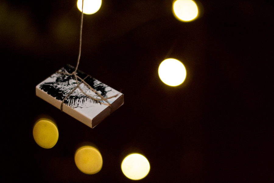 The Creative Writing Department prepares poems inside matchboxes hanging from a tree for OVF.