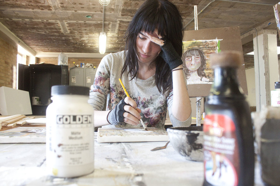 Stephanie Thompson paints in Alexis Hall. Photo by Andrew Koss