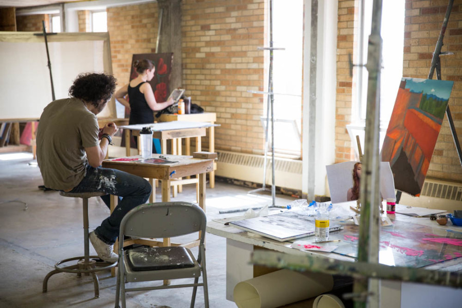 Studio Arts students Juan Rivera and Hannah Gardner take advantage of the abundant natural light in the studio.  Photo by Jessie Leigh