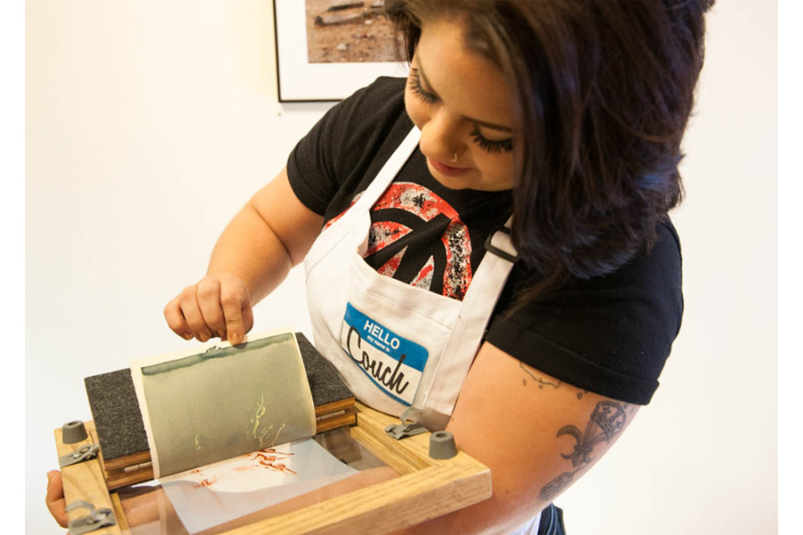 Samantha Podio Inspects the exposure of her print. Once placed in a bath of water this print will transform from a dark green into a vibrant Prussian blue.  Photo by Forrest Soper.