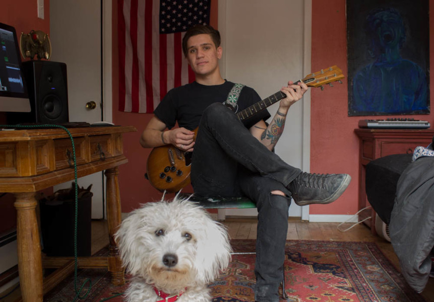 Alex Monasterio and his dog Gimli in his home. Photo by Kyleigh Carter. 