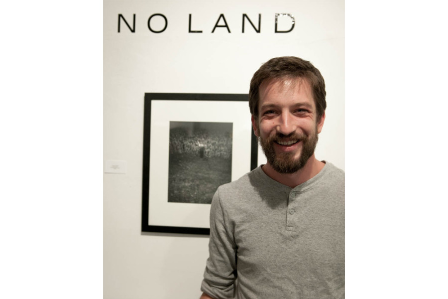 Andrew Coleman stands in front of his artwork. Photo by Forrest Soper.