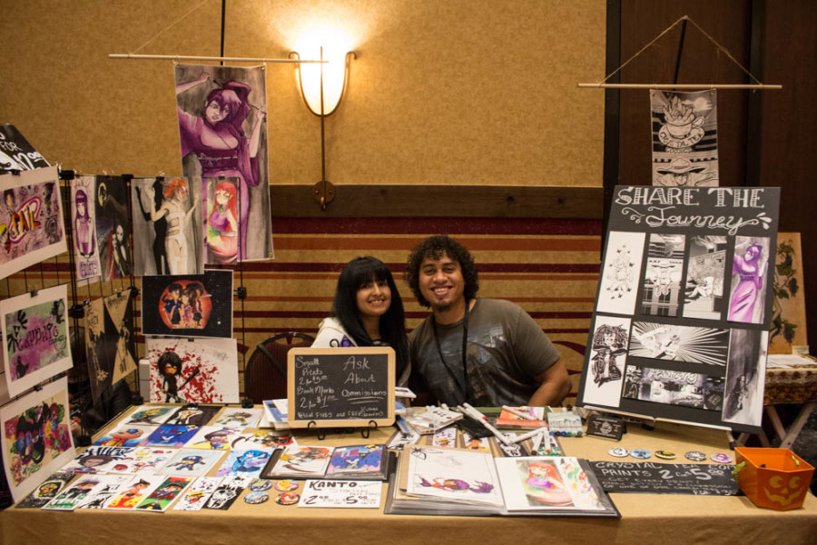 Joshua Fisher and Nicole Lopez sit at their Crystal Tea Comics booth. Photo by Christy Marshall