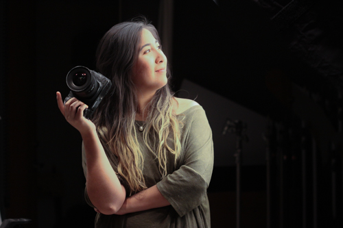 Monica Suarez modeling with her camera. Photo by Jason Stilgebouer.