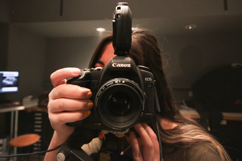Monica Suarez looking through the Lens on set. Photo by Jason Stilgebouer.