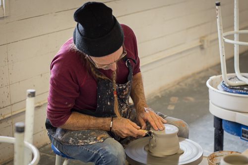 Mike Sutton focused while working on the pottery wheel. Photo by Jason Stilgebouer