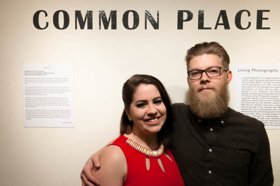 Samantha Podio and Brad Trone stand beside their artist statements at the opening for “Common Place” on Dec. 11. Photo by Forrest Soper 