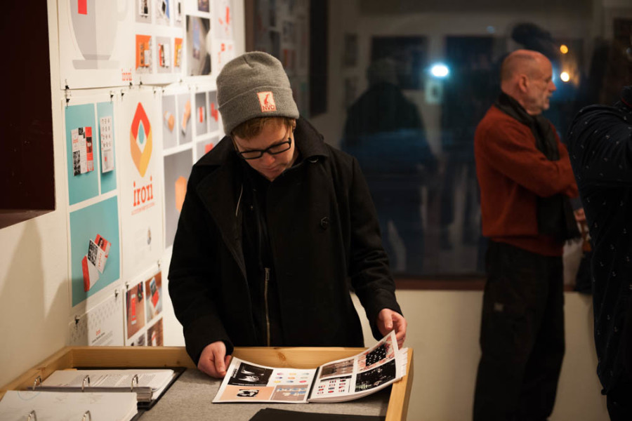A gallery patron views a portfolio of student work at Critical Space on Dec. 14. Photo by Forrest Soper.