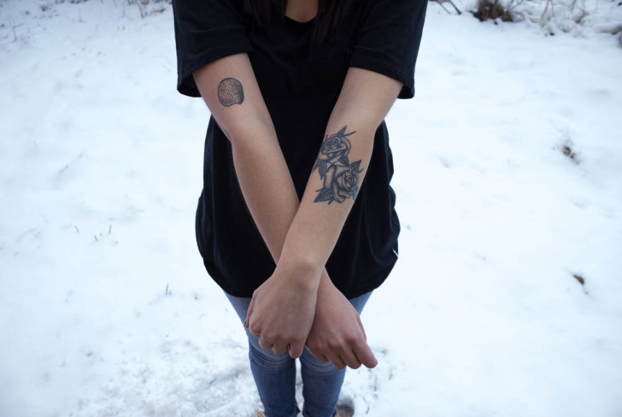 Photography major, Jen Carrillo shows off her new rose tattoo. Photo by Kyleigh Carter. 