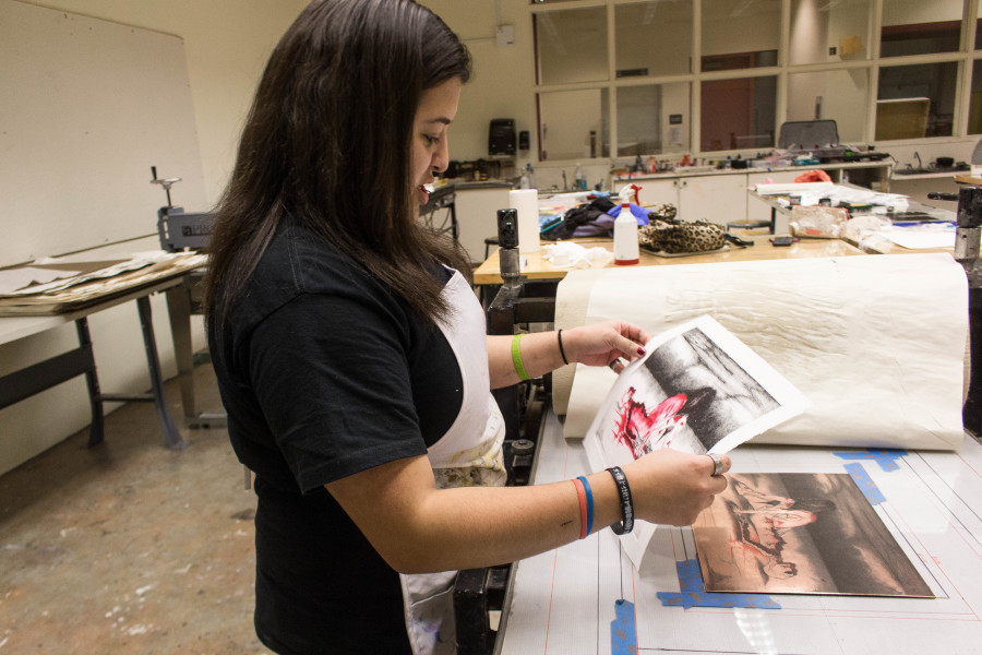 Sen Salinas, a Studio Arts major, spends times in the printmaking studio late at night. Photo by Marco Rivera