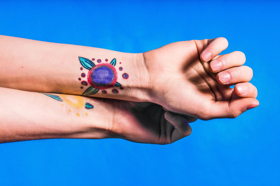 Omar Pedroza shows his two tattoos that were inspired by a brother and sister in The Legend of Zelda, a video game series. The tattoos symbolize the constant support he and his sister give to one another. Photo by Marco Rivera
