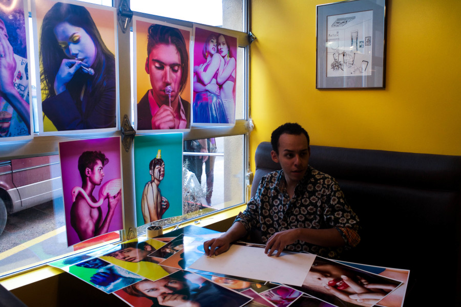 Photography major Marco Rivera organizing his prints for critique. Photo by Whitney Wernick.